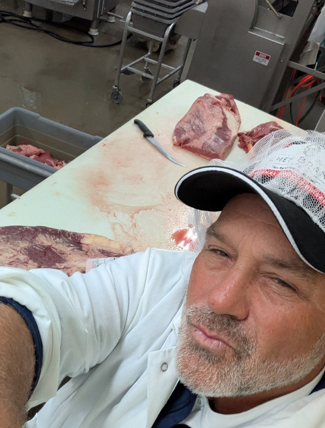 Chef Blair Swiler trimming Choice Brisket at the plant